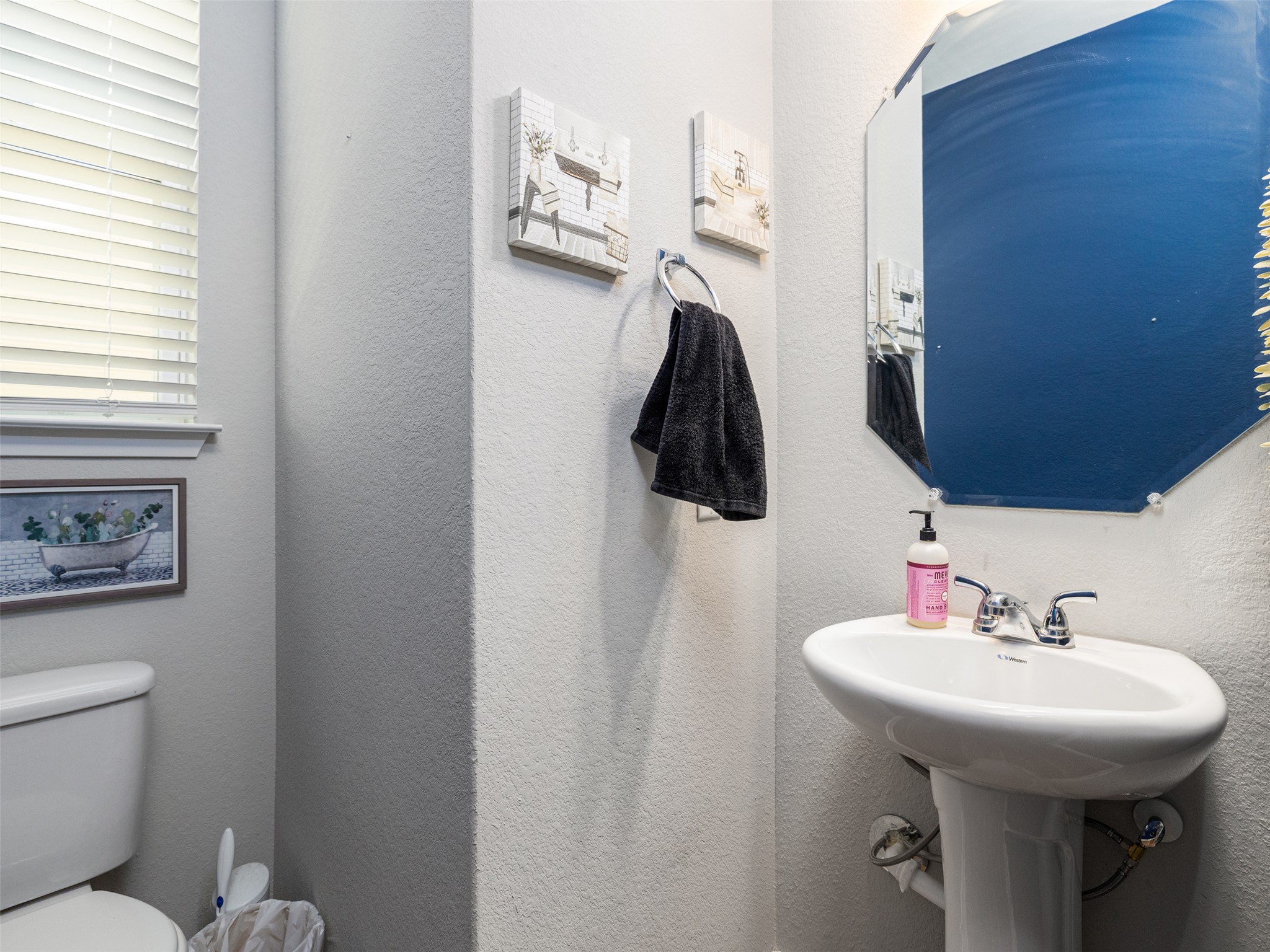 121 Graver Street Georgetown, TX 78626 - Photo 20 of 28 A compact and functional bathroom space features a pedestal sink and bright window.
