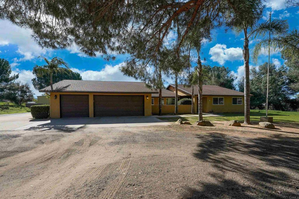 a view of a house with a yard and sitting area