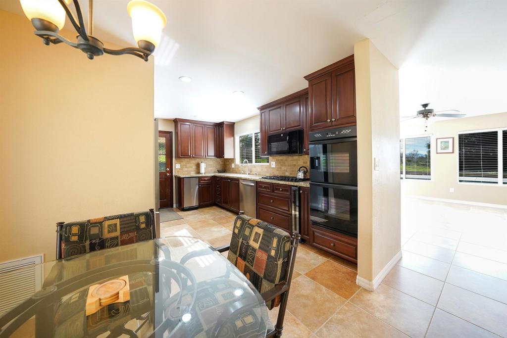 341 Pile Street Ramona, CA 92065 - Photo 12 of 50 a kitchen with stainless steel appliances granite countertop a refrigerator and a stove top oven