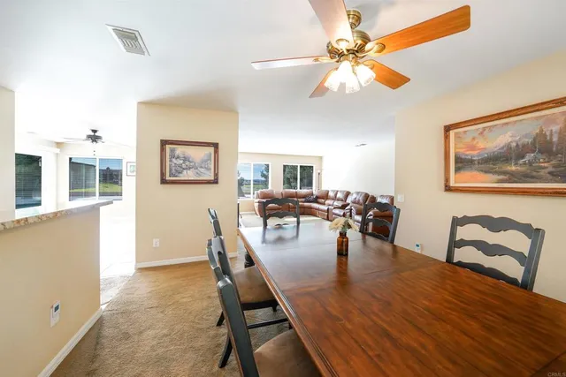 a dining room with furniture and window