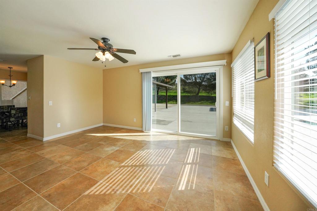 341 Pile Street Ramona, CA 92065 - Photo 17 of 50 a view of a room with a large window and ceiling fan