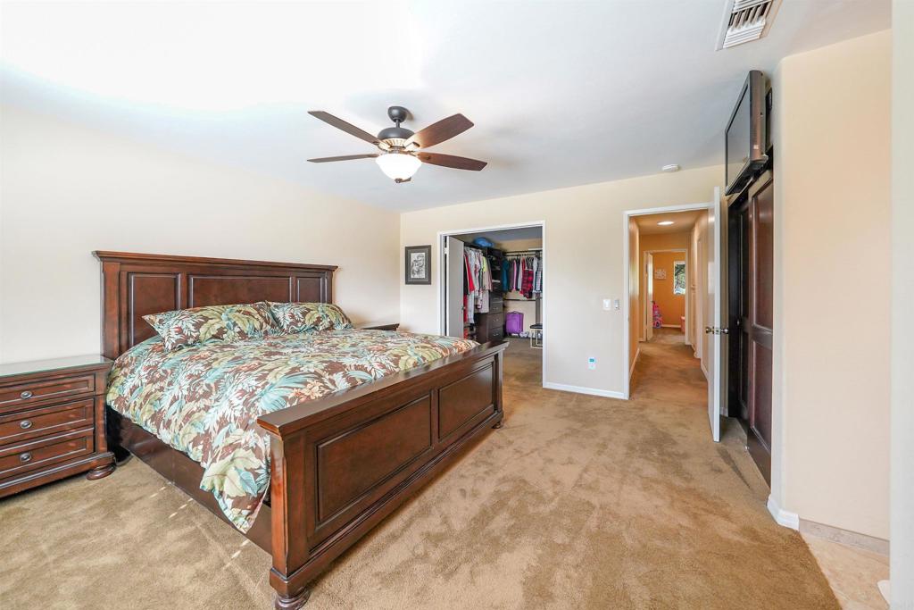 341 Pile Street Ramona, CA 92065 - Photo 22 of 50 a spacious bedroom with a bed and a chandelier