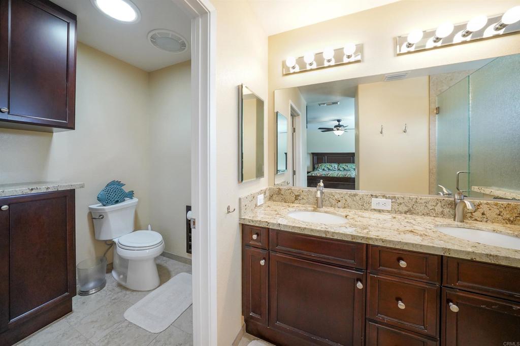 341 Pile Street Ramona, CA 92065 - Photo 24 of 50 a bathroom with a granite countertop toilet sink and mirror