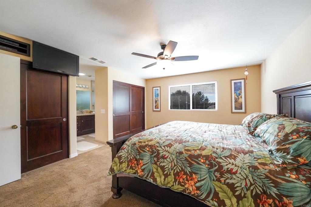 341 Pile Street Ramona, CA 92065 - Photo 26 of 50 a bedroom with a large bed and a window