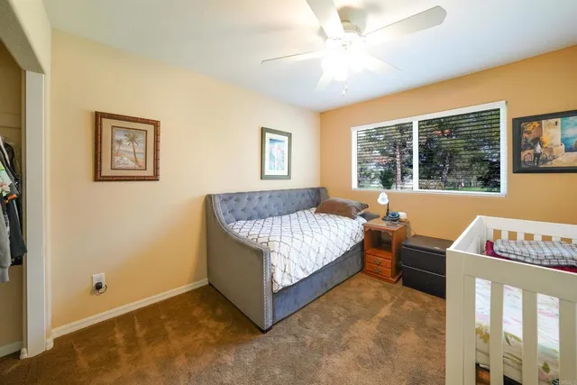 a bathroom with a granite countertop sink a mirror and a shower
