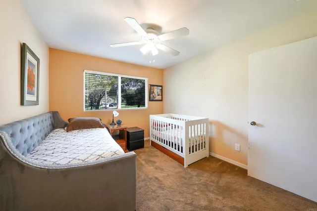 a bathroom with a granite countertop sink a toilet and a mirror