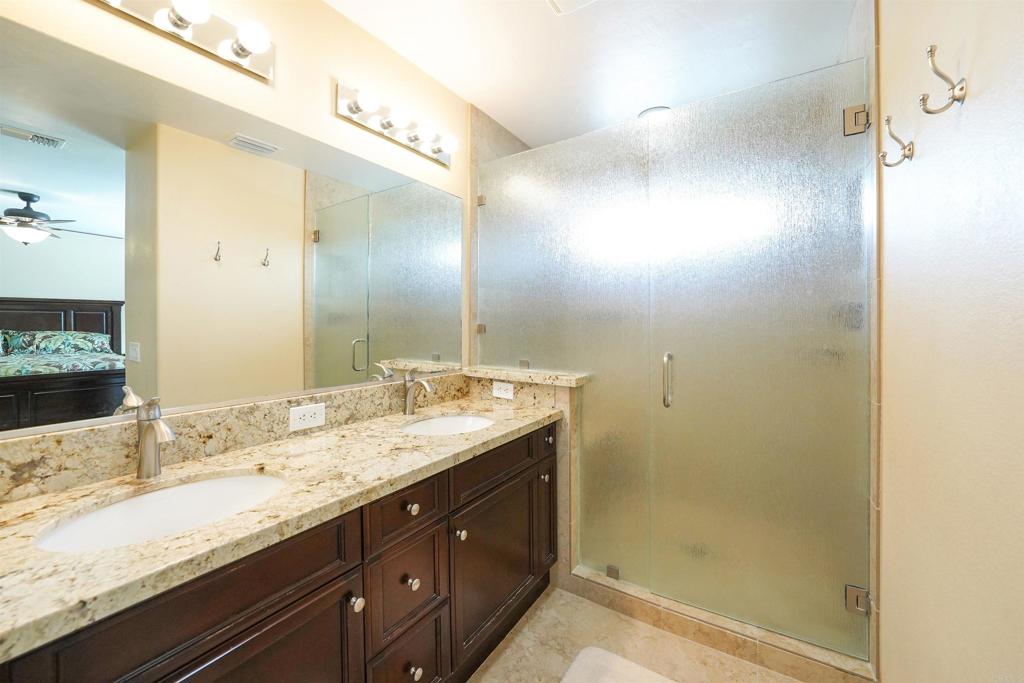 341 Pile Street Ramona, CA 92065 - Photo 31 of 50 a bathroom with a granite countertop sink a mirror and a shower