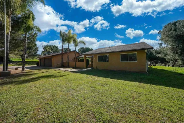 a view of a house with swimming pool and sitting area