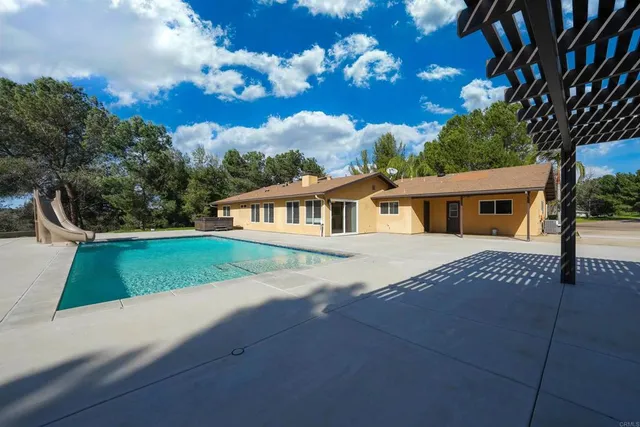 an aerial view of a house with yard swimming pool and outdoor seating