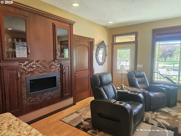 a living room with furniture a window and a fireplace