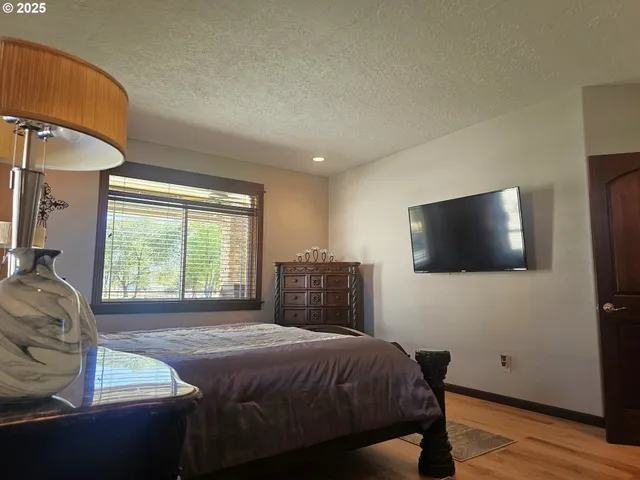 a bedroom with a bed and a flat screen tv