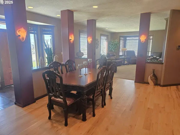 a view of a a dining room with furniture and wooden floor
