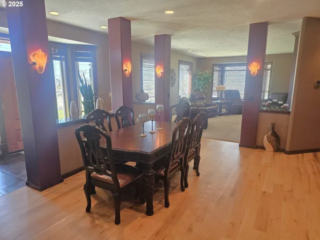 a view of a a dining room with furniture and wooden floor