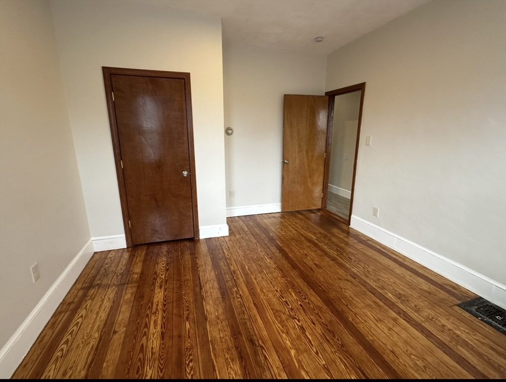 11 Tebroc Street, Unit 2 Boston, MA 02122 - Photo 11 of 17 an empty room with wooden floor and closet