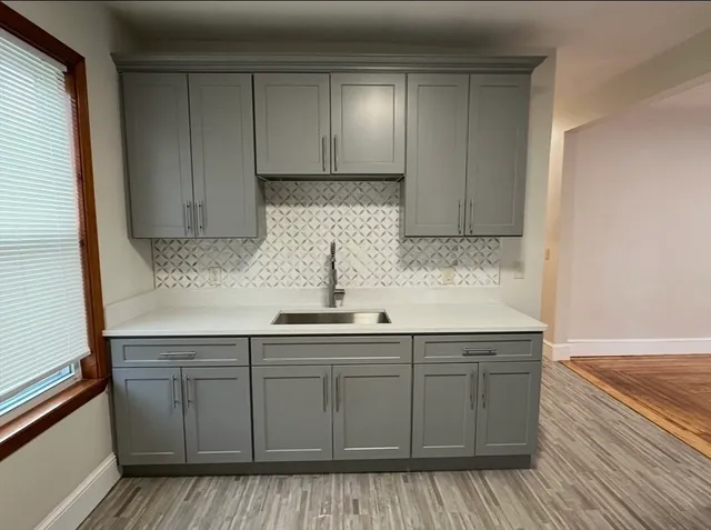 a kitchen with stainless steel appliances granite countertop a sink and wooden cabinets