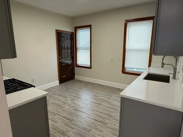 a kitchen with a sink stove and cabinets