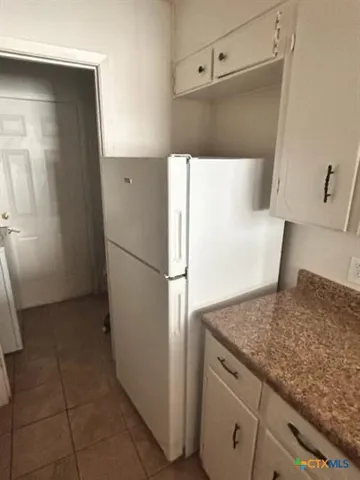 a kitchen with a refrigerator and a sink