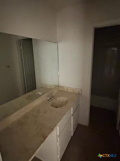 1109 Eastside Drive, Unit C Killeen, TX 76543 - Photo 8 of 9 a bathroom with a granite countertop sink and vanity