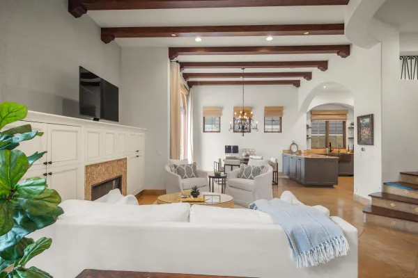 a bedroom with a large bed and a fireplace