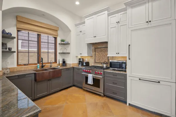 a kitchen with stainless steel appliances granite countertop a stove and a refrigerator