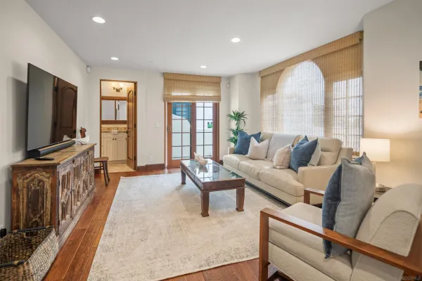 a living room with furniture a flat screen tv and a large window