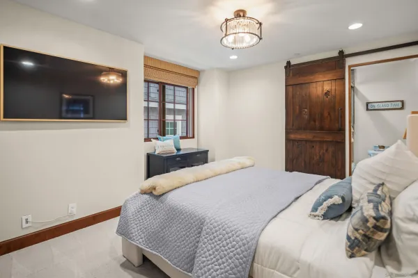 a bedroom with a large bed and a large window