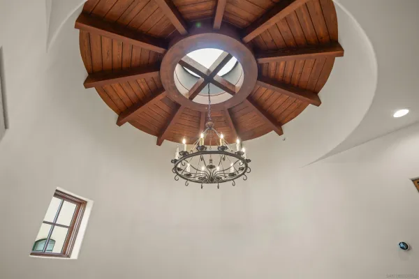 a front view of a livingroom with a couch and chandelier