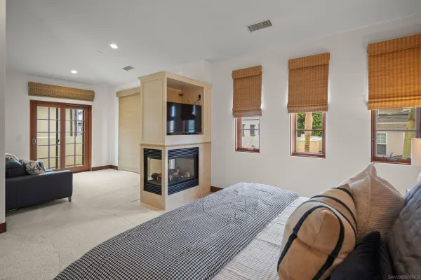 a bedroom with a large bed and a couch