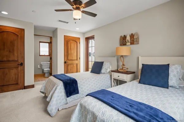 a bedroom with two beds and painting on the wall