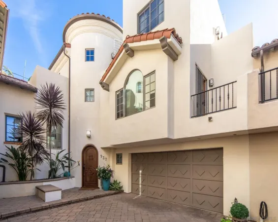 a view of a white house with large windows