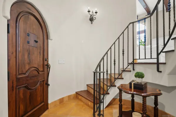 a view of staircase with wooden floor and fan