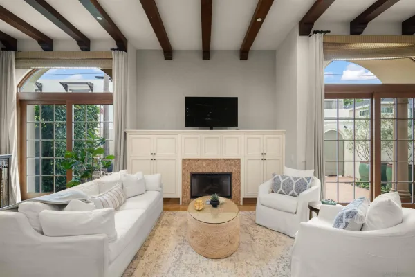 a living room with furniture a fireplace and a flat screen tv