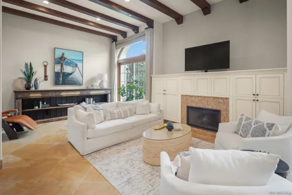 a living room with furniture a fireplace and a flat screen tv