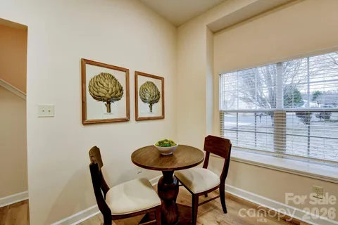 a view of a dining room with furniture and a large window