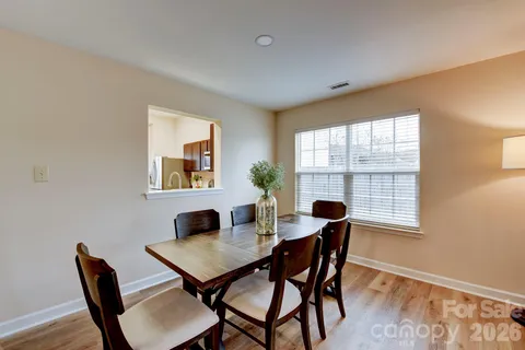 a view of a dining room with furniture and window