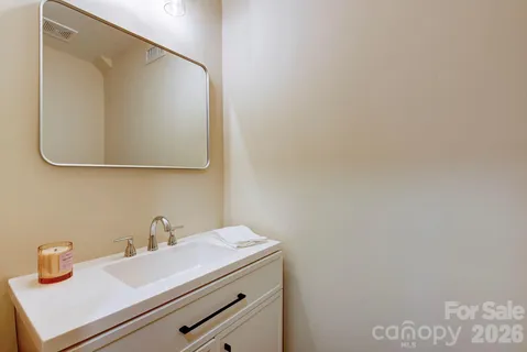 a bathroom with a sink and mirror