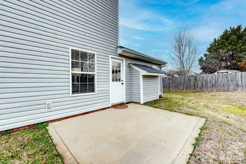 a view of a backyard with a large tree