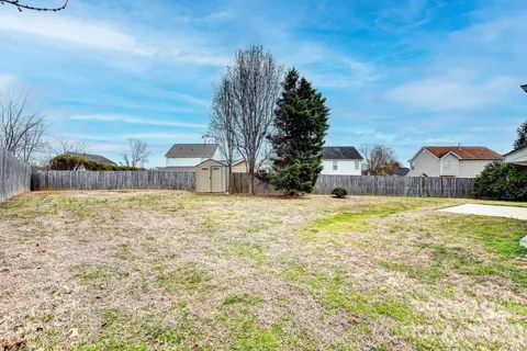 a swimming pool with outdoor seating and yard