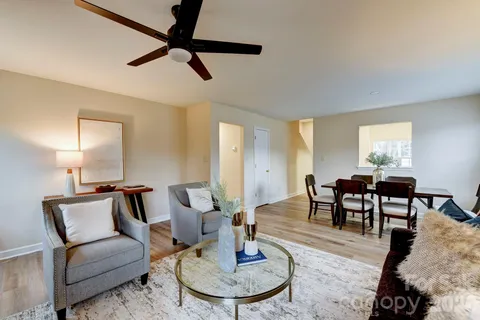 a living room with furniture a rug and a chandelier