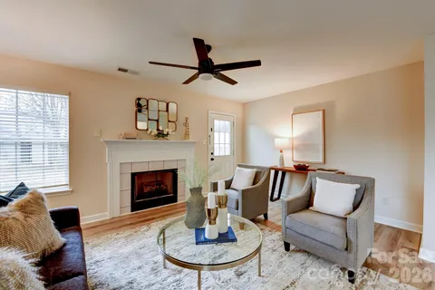 a living room with furniture and a fireplace