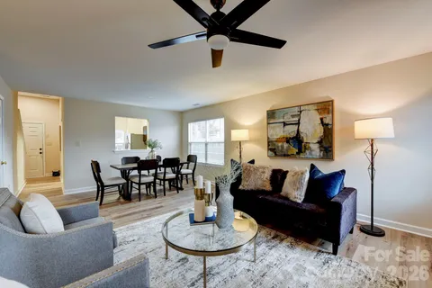 a living room with furniture and a dining table