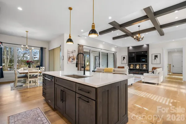 a kitchen with stainless steel appliances kitchen island granite countertop a sink and cabinets