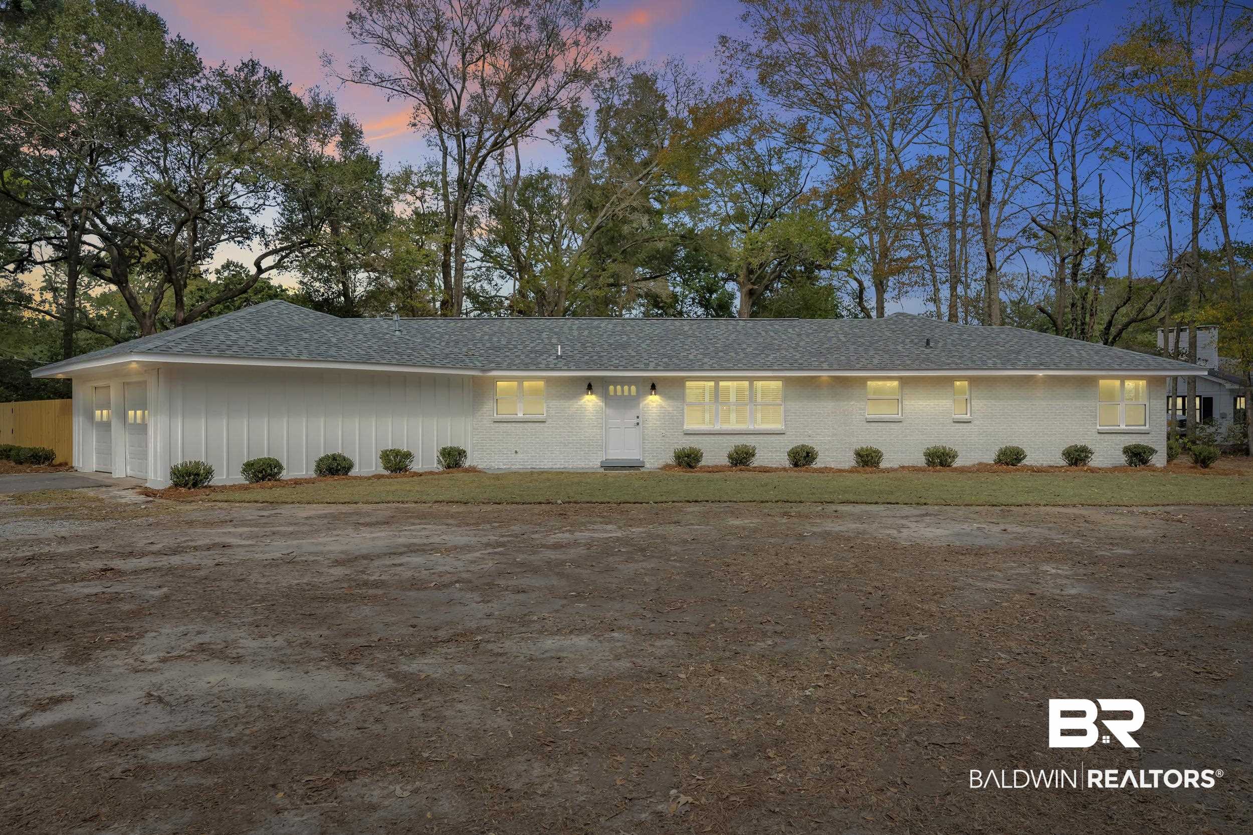 1409 Altair Lane Mobile, AL 36693 - Photo 1 of 23 View of front facade featuring a garage, dirt driveway, a shingled roof, and a front yard
