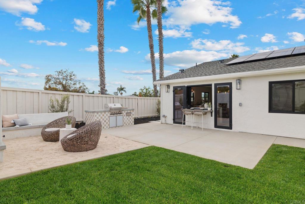 161 Countryhaven Road Encinitas, CA 92024 - Photo 20 of 26 a view of a patio with table and chairs potted plants with wooden fence