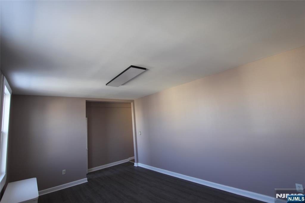 10 Orchard Street, Unit 2 Elmwood Park, NJ 07407 - Photo 11 of 12 an empty room with wooden floor and ceiling fan
