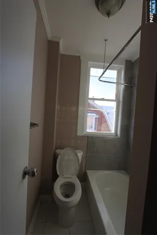 a bathroom with a tub sink and window
