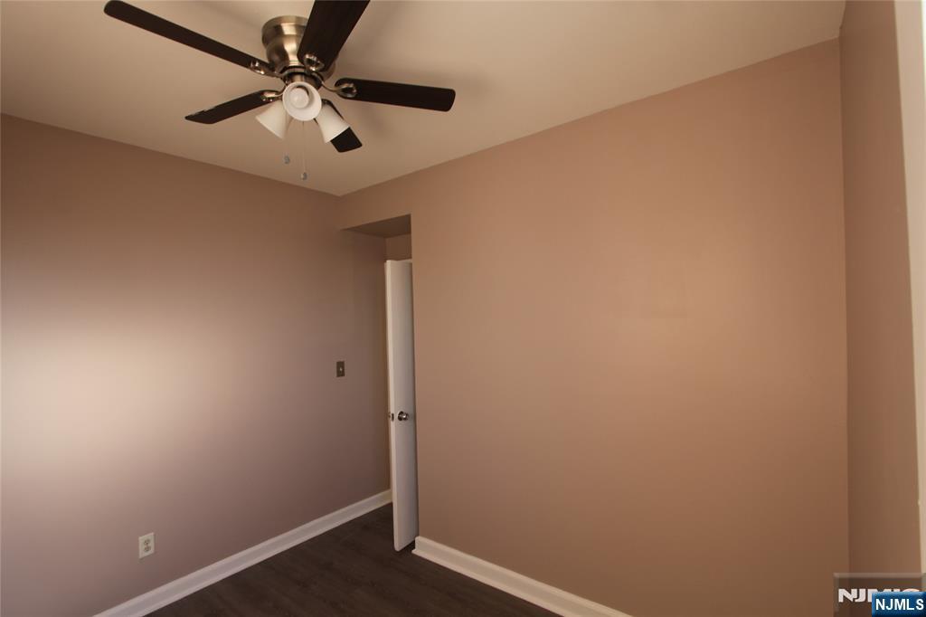 10 Orchard Street, Unit 2 Elmwood Park, NJ 07407 - Photo 10 of 12 an empty room with a window and a fan