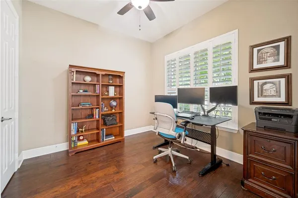 a view of a workspace with furniture and a window