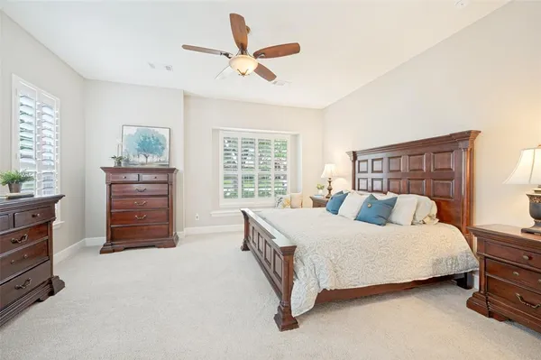 a bedroom with a bed a dresser and a window