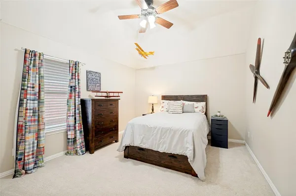 a bedroom with a bed and a ceiling fan